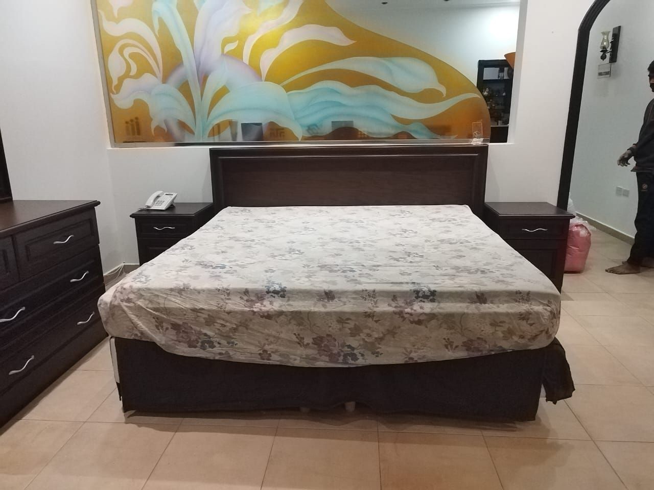 A premium full bedroom furniture set featuring a rich natural wood oak finish, including a clean-lined bedframe with an integrated headboard, two matching minimalist nightstands, a spacious multi-drawer dresser, and a large matching wardrobe closet. - Photo 3