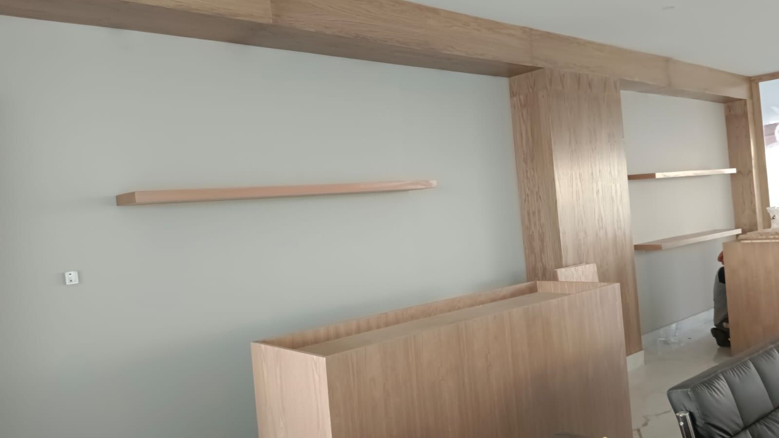 Comprehensive commercial interior woodwork including ash wood wall cladding, structural column wraps, floating shelves, service counters, and geometric grid display plinths. - Photo 4