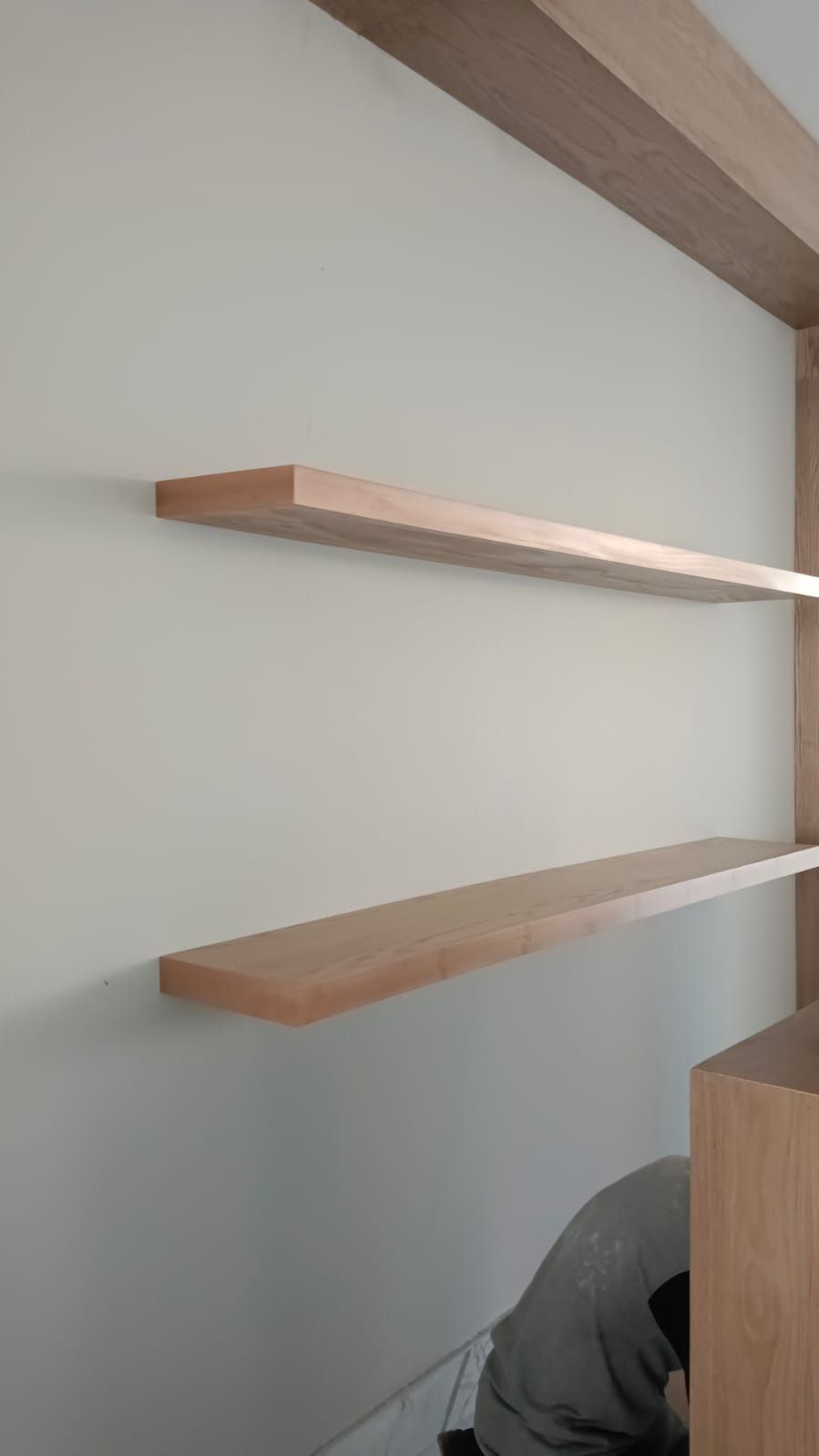 Comprehensive commercial interior woodwork including ash wood wall cladding, structural column wraps, floating shelves, service counters, and geometric grid display plinths. - Photo 6