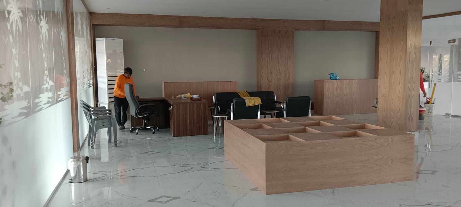 Comprehensive commercial interior woodwork including ash wood wall cladding, structural column wraps, floating shelves, service counters, and geometric grid display plinths. - Photo 7