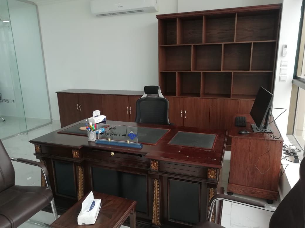A classic, professional executive office suite featuring a dark mahogany-finished wooden desk paired with a matching large storage cabinet assembly containing lower doors and open upper square shelving grid. - Photo 2