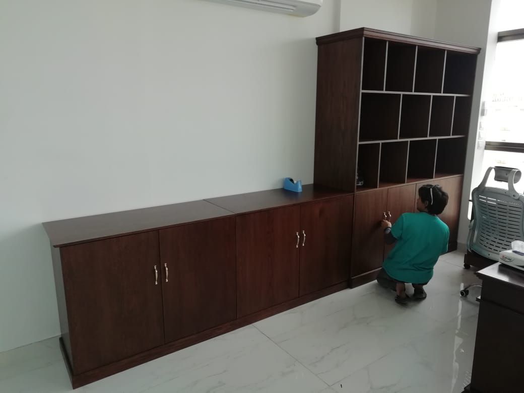 A classic, professional executive office suite featuring a dark mahogany-finished wooden desk paired with a matching large storage cabinet assembly containing lower doors and open upper square shelving grid. - Photo 3
