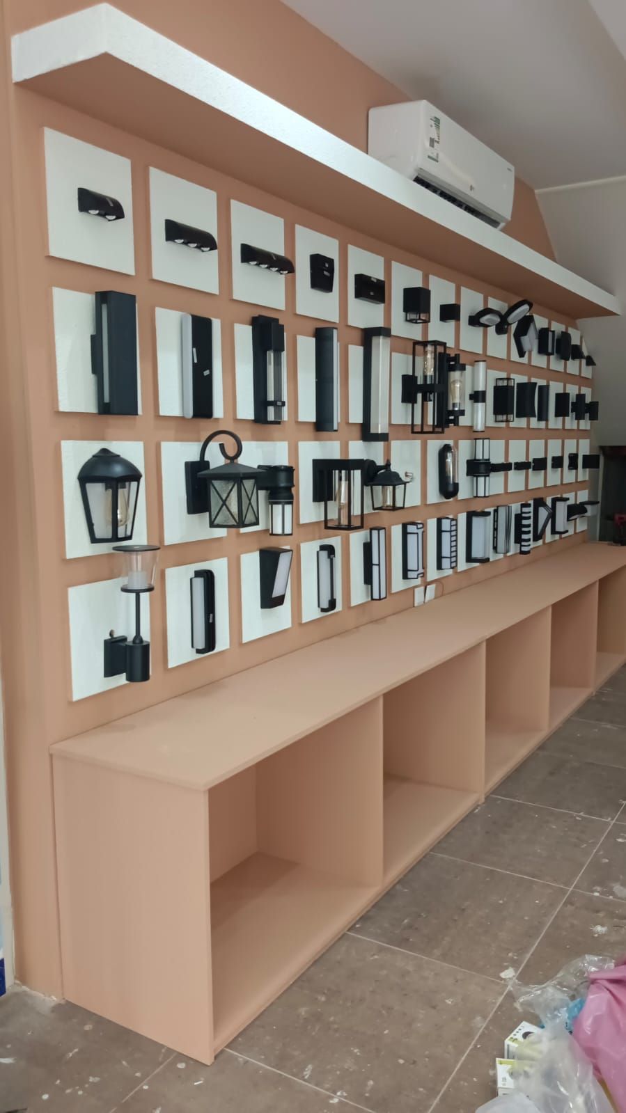 A commercial retail display set featuring wall-mounted slatwall panels with insertion grooves alongside coordinating square modular storage cabinets. - Photo 1
