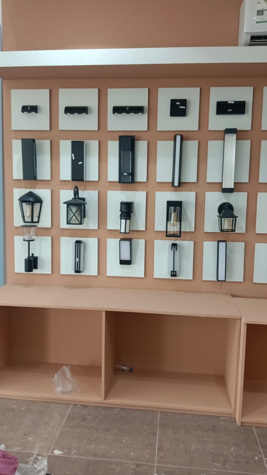 A commercial retail display set featuring wall-mounted slatwall panels with insertion grooves alongside coordinating square modular storage cabinets. - Photo 4