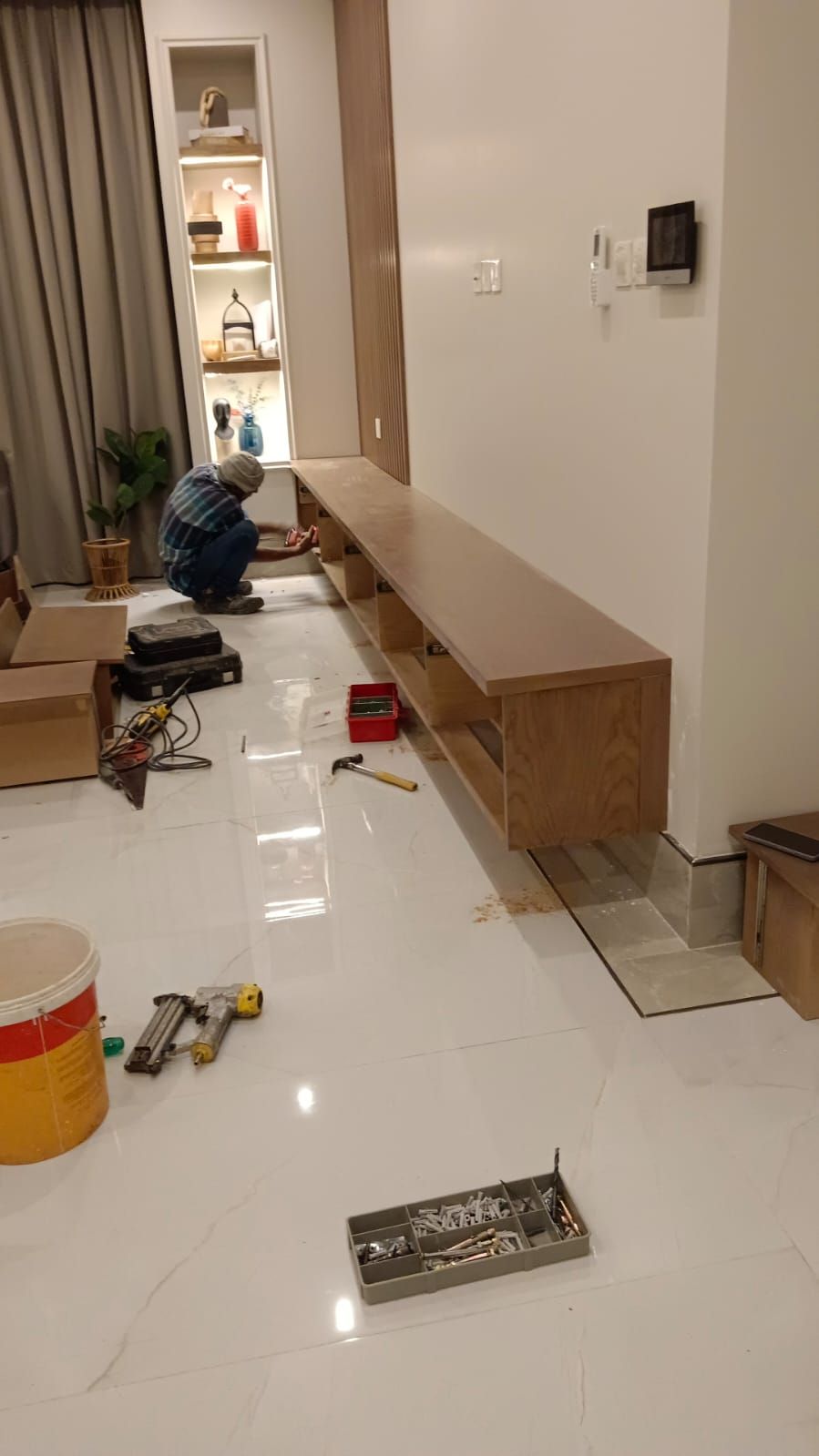 A minimalist wall-mounted television back panel assembly integrated with a low-profile floating media shelf underneath and a matching vertical open-shelf unit tucked into the corner. - Photo 3